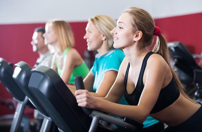 positive adults in gym working out at group class
